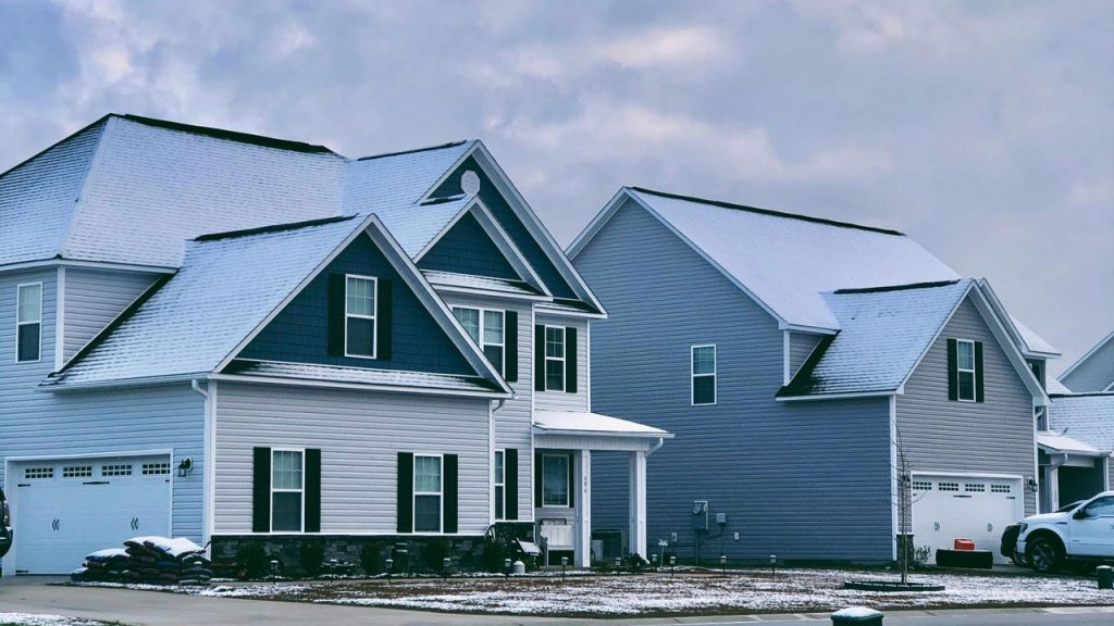 Snow-covered residential roofs in Tulsa, Oklahoma, showing winter weather conditions that impact roofing, by Native Roofing & Construction.